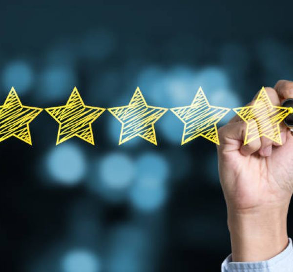 Businessman writing yellow five star to customer evaluation service and product. Marketing review and evaluation concept.